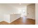 Upstairs hallway with wood floors, white walls, and natural lighting from a window at 261 Dahlia Dr, Woodstock, GA 30188