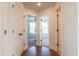 Hallway with wood floors and doors leading into bedrooms at 261 Dahlia Dr, Woodstock, GA 30188