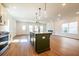 Modern kitchen with a large island, pendant lighting, and stainless steel appliances at 261 Dahlia Dr, Woodstock, GA 30188