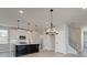 Modern kitchen with white cabinets, large island, and pendant lighting at 261 Dahlia Dr, Woodstock, GA 30188