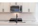 The kitchen offers stainless steel appliances and a stylish black faucet at 261 Dahlia Dr, Woodstock, GA 30188