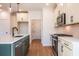 View of a kitchen with an island, stainless steel appliances, and neutral-toned cabinets at 261 Dahlia Dr, Woodstock, GA 30188