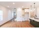 Bright living room featuring hardwood floors, recessed lighting, and an open floor plan to kitchen and stairs at 261 Dahlia Dr, Woodstock, GA 30188