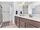 Elegant bathroom with dual sinks, a large mirror, and a walk-in shower at 3501 Great Sky Pkwy, Canton, GA 30114