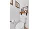 Clean bathroom with toilet and floating shelf; wood-look flooring at 3501 Great Sky Pkwy, Canton, GA 30114