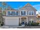 Two-story house with gray siding, brick accents, and a two-car garage at 3501 Great Sky Pkwy, Canton, GA 30114