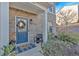 Front porch with blue door, wreath, and seating at 3501 Great Sky Pkwy, Canton, GA 30114