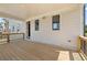 Covered back porch with wooden deck, white siding, and black framed windows at 5247 Flannery Chase Sw, Powder Springs, GA 30127