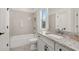 Bathroom features white cabinets, granite counters and shower-tub combination at 5247 Flannery Chase Sw, Powder Springs, GA 30127