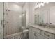 A modern bathroom with glass shower, white vanity, granite countertop, decorative tile floor, and vanity mirror at 5247 Flannery Chase Sw, Powder Springs, GA 30127