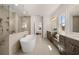 Modern bathroom with double vanity, large free standing soaking tub, and glass enclosed shower at 5247 Flannery Chase Sw, Powder Springs, GA 30127