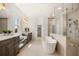 Bright bathroom with double vanity, free standing soaking tub, and glass enclosed shower at 5247 Flannery Chase Sw, Powder Springs, GA 30127