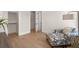 Bright bedroom with hardwood floors, large windows, designer chaise lounge, and a view to the entryway at 5247 Flannery Chase Sw, Powder Springs, GA 30127