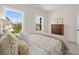 Bright bedroom featuring two windows, a comfortable bed, and a view of the landscaped yard at 5247 Flannery Chase Sw, Powder Springs, GA 30127