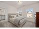 Bedroom features natural light, neutral decor, and a view to the bathroom at 5247 Flannery Chase Sw, Powder Springs, GA 30127