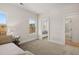 Bedroom featuring two windows for natural light and a view to the adjacent bathroom at 5247 Flannery Chase Sw, Powder Springs, GA 30127