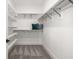 Walk in closet with shelves and racks for organized storage and a blue pillow at 5247 Flannery Chase Sw, Powder Springs, GA 30127