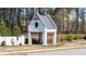 Community entrance with a pergola featuring a Gathering silhouette at 5247 Flannery Chase Sw, Powder Springs, GA 30127