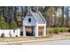 A white brick structure featuring a Gathering silhouette and a metal roof at 5247 Flannery Chase Sw, Powder Springs, GA 30127