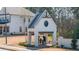 A white brick structure featuring a Gathering silhouette and a metal roof at 5247 Flannery Chase Sw, Powder Springs, GA 30127