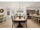 Open dining area with hardwood floors, chandelier, and seamless access to kitchen at 5247 Flannery Chase Sw, Powder Springs, GA 30127