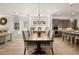 Open concept dining room with a long wooden table and chandelier at 5247 Flannery Chase Sw, Powder Springs, GA 30127