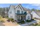Inviting two-story home featuring a charming front porch, stone accents, and manicured landscaping at 5247 Flannery Chase Sw, Powder Springs, GA 30127