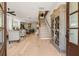 Inviting foyer with wood floors, staircase, and decorative cabinet showcase at 5247 Flannery Chase Sw, Powder Springs, GA 30127