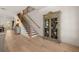 Elegant foyer featuring wood floors, staircase, and antique cabinet at 5247 Flannery Chase Sw, Powder Springs, GA 30127