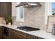The modern kitchen features stainless steel appliances, gas range, grey backsplash, and quartz countertops at 5247 Flannery Chase Sw, Powder Springs, GA 30127