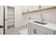 Laundry room features lots of storage with cabinets and open shelving at 5247 Flannery Chase Sw, Powder Springs, GA 30127