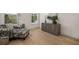 Bright living room with hardwood floors, large windows, designer decor, and a gray storage unit at 5247 Flannery Chase Sw, Powder Springs, GA 30127