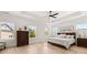 Bright main bedroom with hardwood floors, tray ceiling, and large windows offering plenty of natural light at 5247 Flannery Chase Sw, Powder Springs, GA 30127