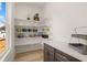 The spacious pantry features ample shelving and storage space with designer light fixtures at 5247 Flannery Chase Sw, Powder Springs, GA 30127