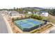Community tennis courts are shown from above, and surrounded by a fence and landscaping at 5247 Flannery Chase Sw, Powder Springs, GA 30127