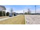 A community sand volleyball court with benches and landscaping on a sunny day at 5247 Flannery Chase Sw, Powder Springs, GA 30127