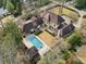 Aerial view of an estate with a large in-ground pool, manicured lawn, mature trees, and lush landscaping at 2631 Habersham Nw Rd, Atlanta, GA 30305