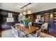 Traditional dining room boasts dark wood paneling, built-in bookshelves and a large wooden table at 2631 Habersham Nw Rd, Atlanta, GA 30305