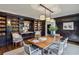 Refined dining room with dark wood walls, custom built-ins, and a large dining table with seating at 2631 Habersham Nw Rd, Atlanta, GA 30305