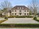 Stunning two-story home with a symmetrical facade, beautiful landscaping and a circular gravel driveway at 2631 Habersham Nw Rd, Atlanta, GA 30305