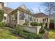 A stunning home exterior featuring a mix of stone and stucco, lush landscaping, and a private courtyard at 2631 Habersham Nw Rd, Atlanta, GA 30305