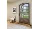 Inviting foyer featuring stone tile flooring, a striking glass paneled front door, and natural light at 2631 Habersham Nw Rd, Atlanta, GA 30305