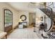 Grand foyer with a curved staircase, zebra print runner, stone floors, and designer decor at 2631 Habersham Nw Rd, Atlanta, GA 30305