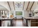 Open kitchen concept with oversized island, high ceilings, stainless steel appliances, and dark wood floors at 2631 Habersham Nw Rd, Atlanta, GA 30305