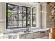 Kitchen sink in front of large window viewing outdoor stone structure and landscaped backyard at 2631 Habersham Nw Rd, Atlanta, GA 30305