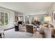 Bright living room featuring neutral decor, large windows, a fireplace, and ample seating at 2631 Habersham Nw Rd, Atlanta, GA 30305