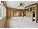 Large living room features plush carpeting, ceiling fan, and a built-in entertainment center with cabinets and display shelves at 2631 Habersham Nw Rd, Atlanta, GA 30305