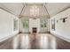 Spacious living room features hardwood floors, a stone fireplace, a decorative light fixture and natural light at 2631 Habersham Nw Rd, Atlanta, GA 30305