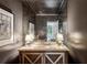 Elegant powder room showcases an antique mirror, marble countertop, and a stylish vessel sink with designer fixtures at 2631 Habersham Nw Rd, Atlanta, GA 30305