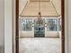 Bright sunroom with brick floors, whitewashed wood ceiling, iron chandelier and expansive windows offering lovely views at 2631 Habersham Nw Rd, Atlanta, GA 30305